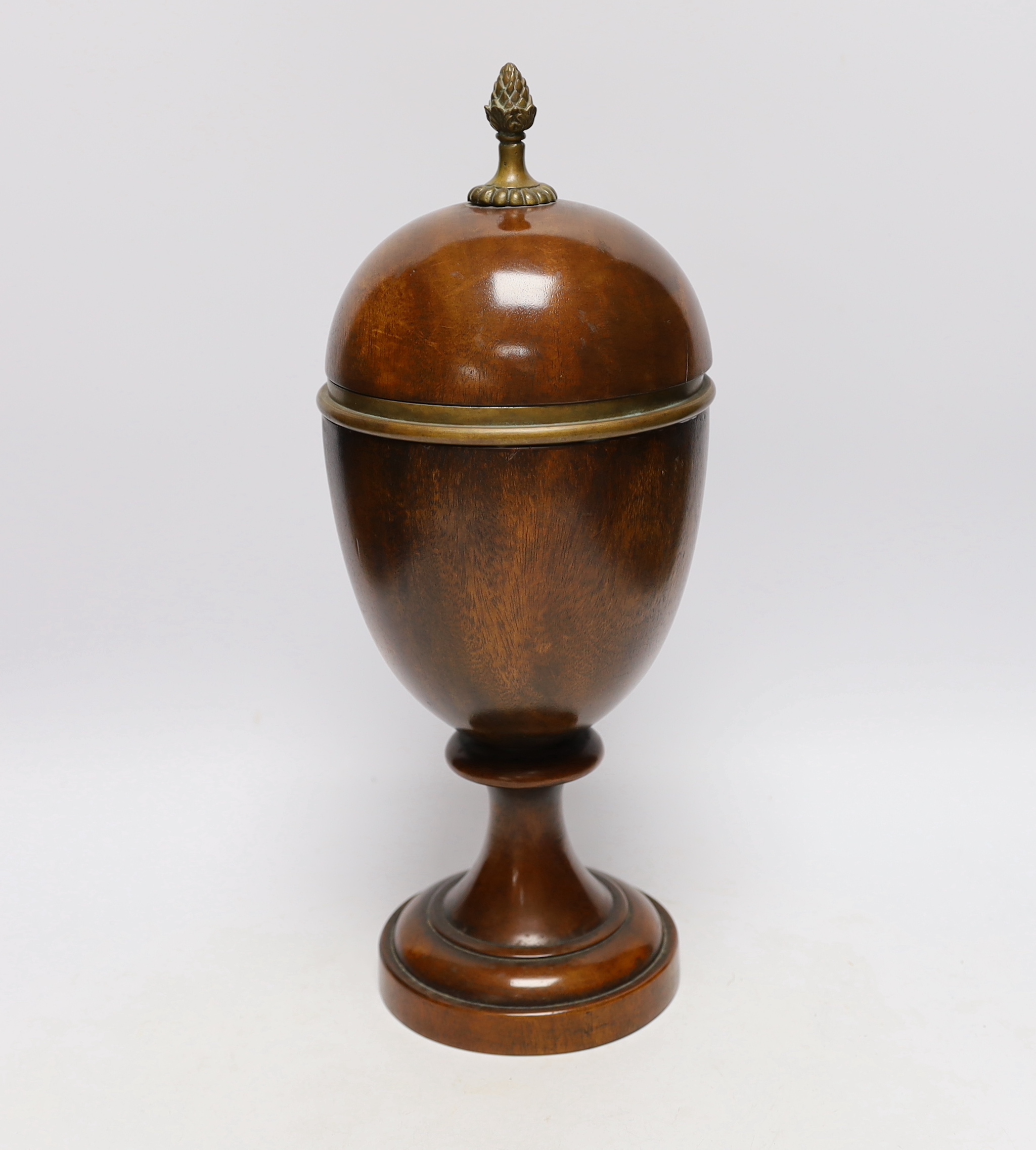 A turned wood urn and cover with brass acorn finial, 37cm high